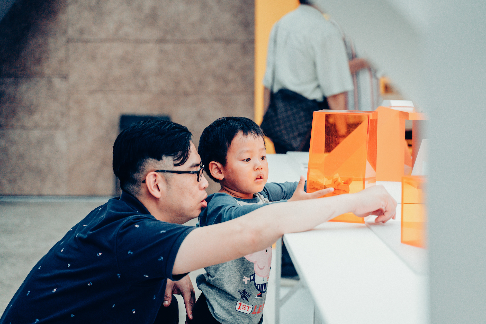 「美角，生活中的每一課2.0」成果展活動側拍，小男孩跟爸爸一起玩橘色教具。