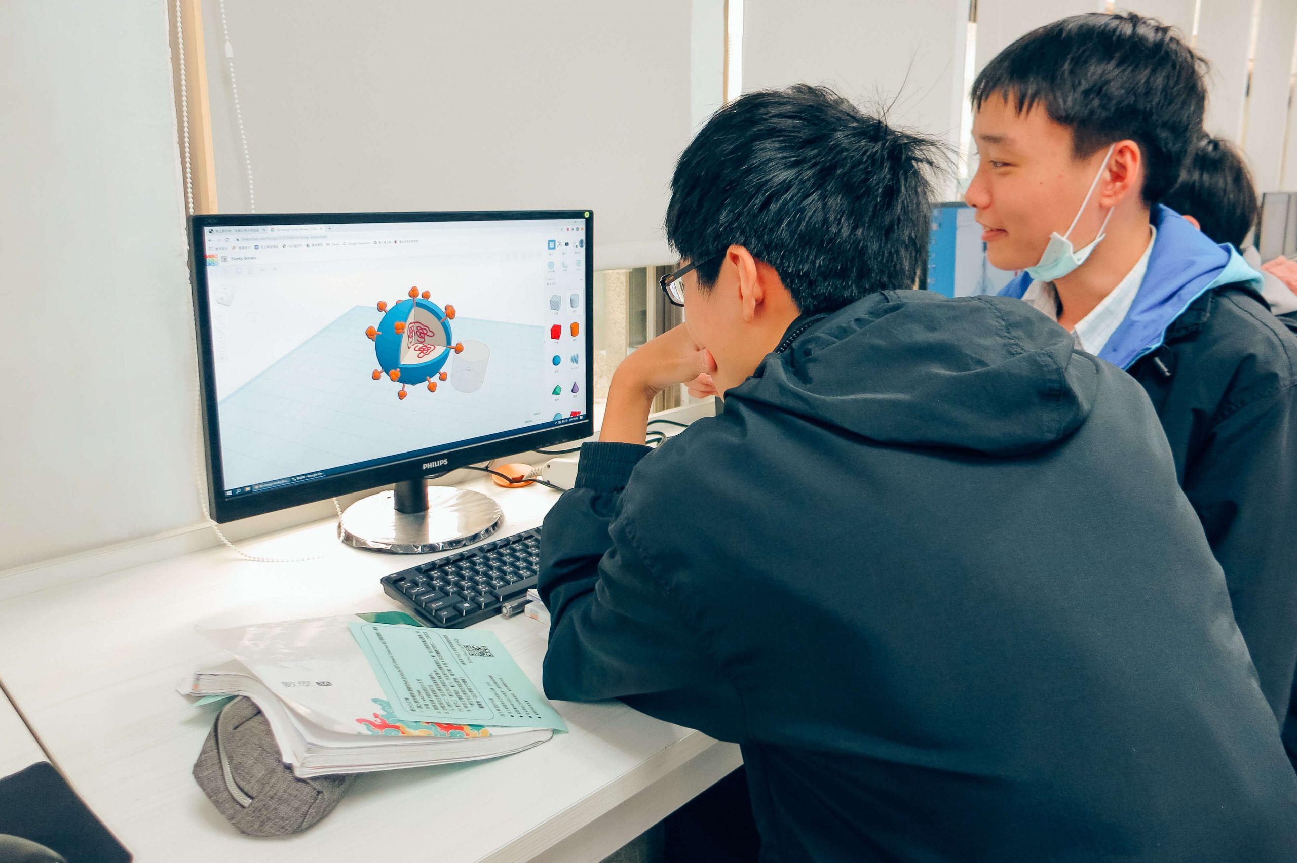 兩位男學生在電腦前操作建模軟體